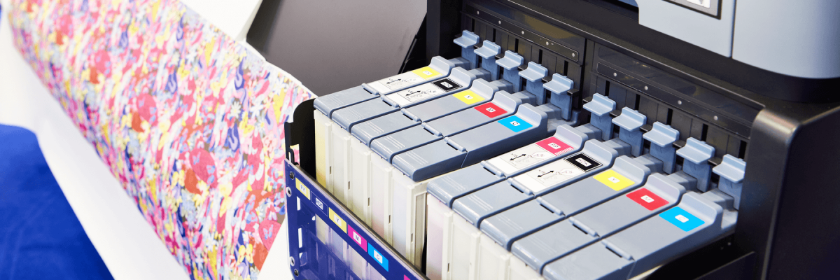 Large colorful printed paper and ink cartridges on a printer 