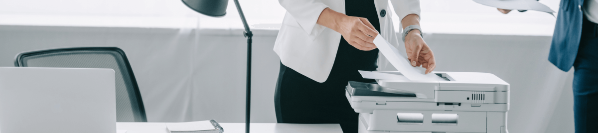Woman using a printer in the office.