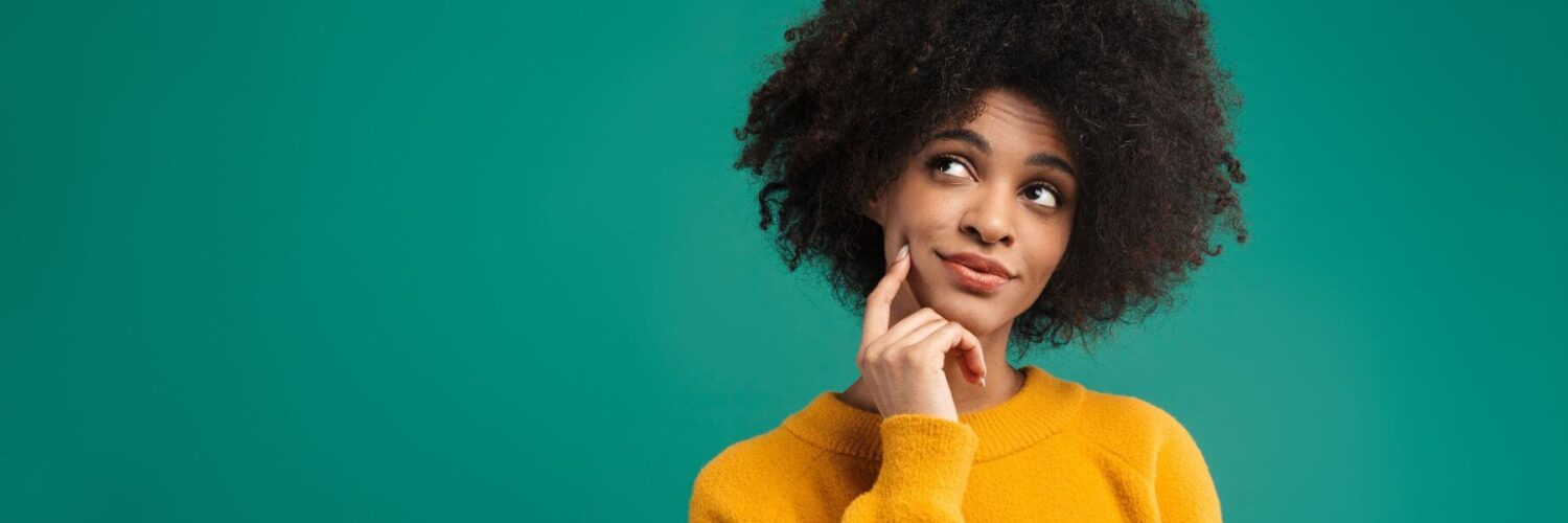 Person looking up with finger on cheek